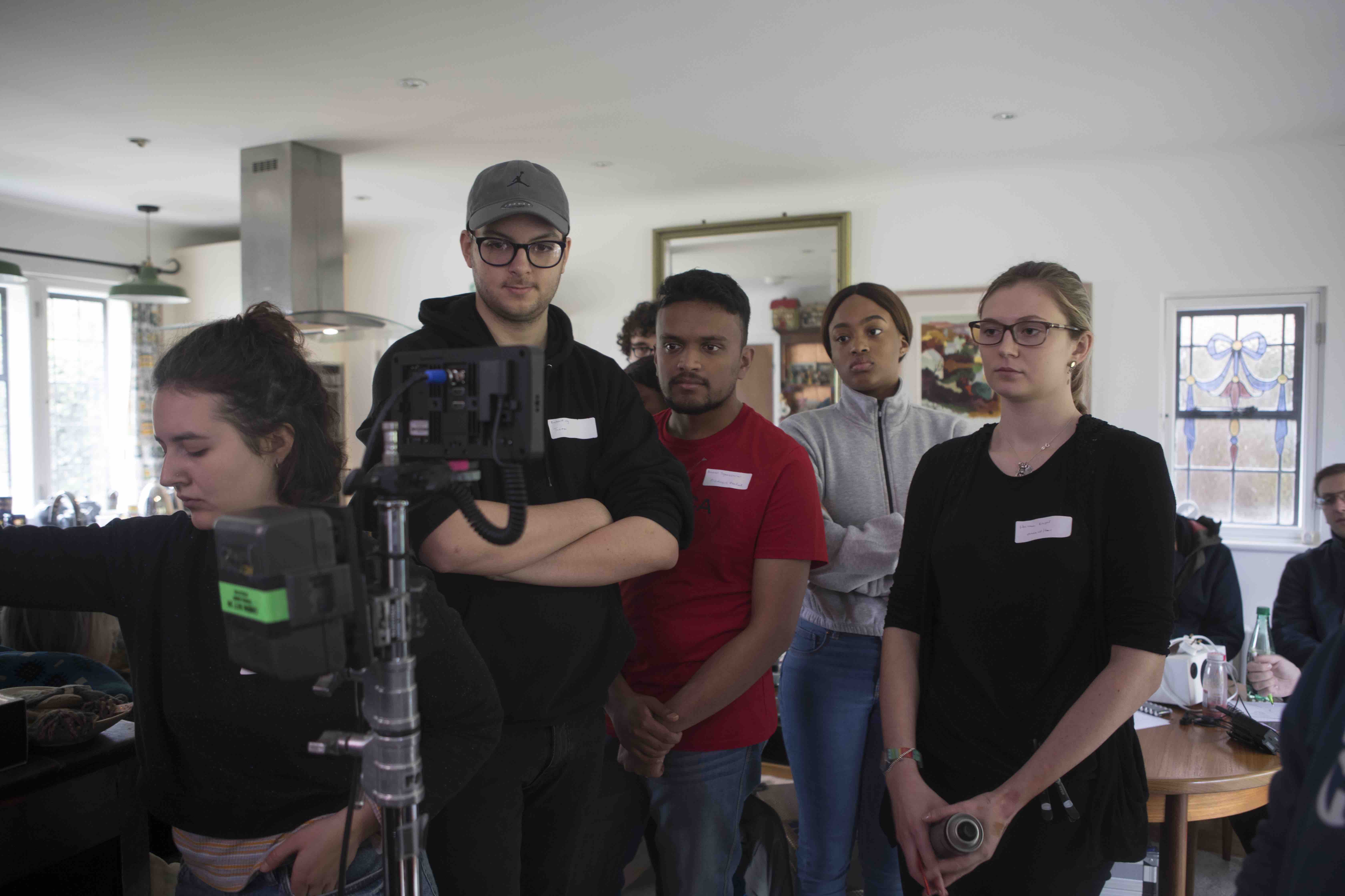 Behind the scenes on Transference, the crew watching a take in the kitchen
