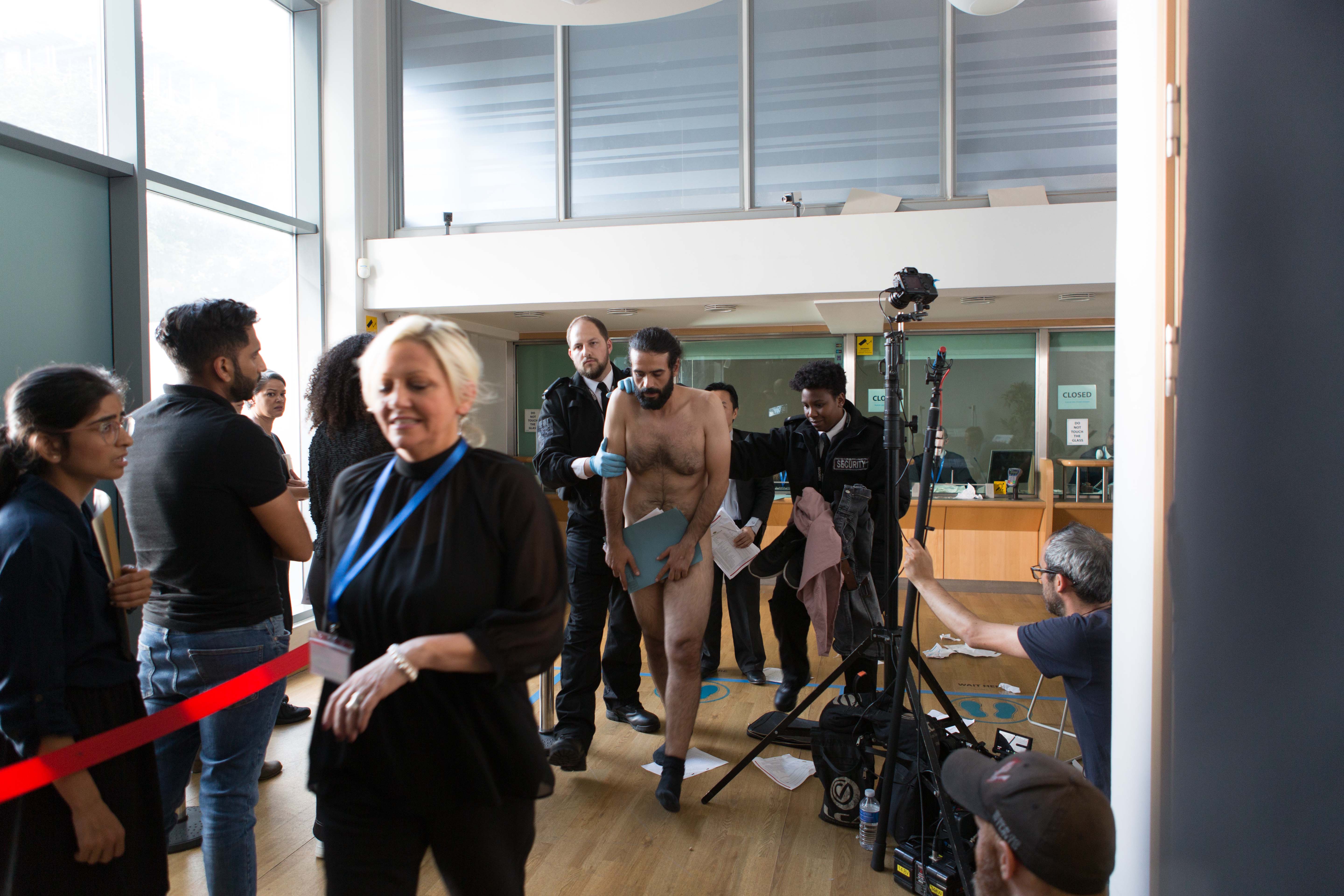 Behind the scenes on Leave to Remain, cast and crew gathered in an office location